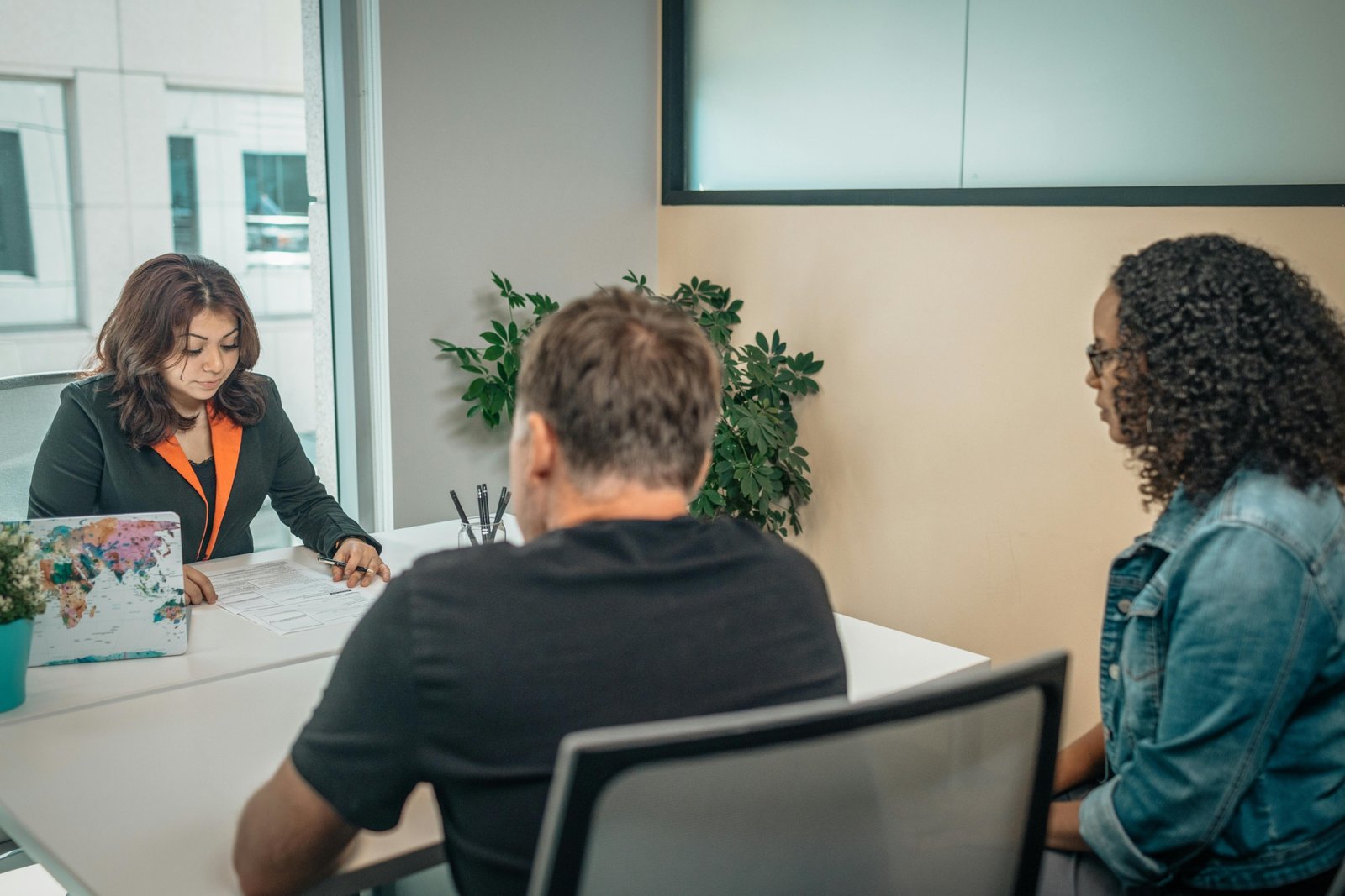Travel agent helping clients plan personalized trips at Big D Travel Center in Irving Texas