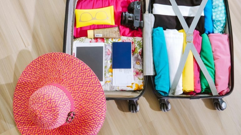 Baseball hat protected inside a travel case packed in a suitcase for safe and organized travel