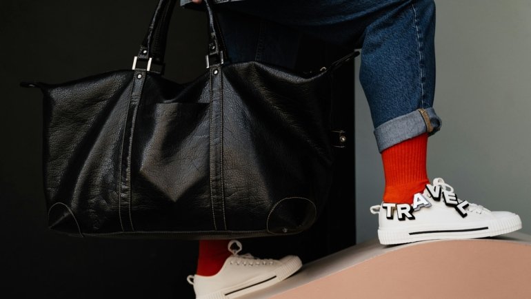 Travel bag with separate shoe compartment neatly packing shoes and clothes for organized travel