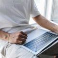 User logging into travel insurance consultants online portal on laptop for secure account management