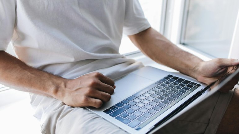 User logging into travel insurance consultants online portal on laptop for secure account management