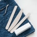 Compact nail care travel kit with stainless steel tools neatly organized beside travel essentials