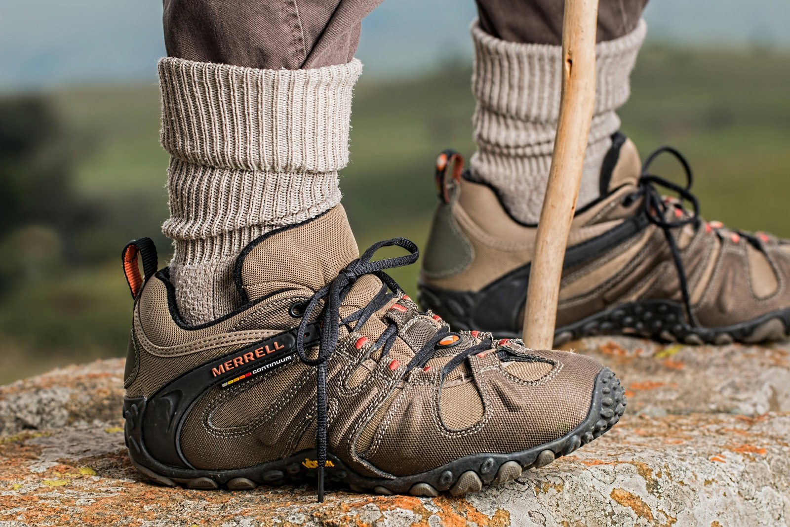 Comfortable travel shoes worn by a traveler walking outdoors on mixed terrain, showcasing style and durability for various travel activities