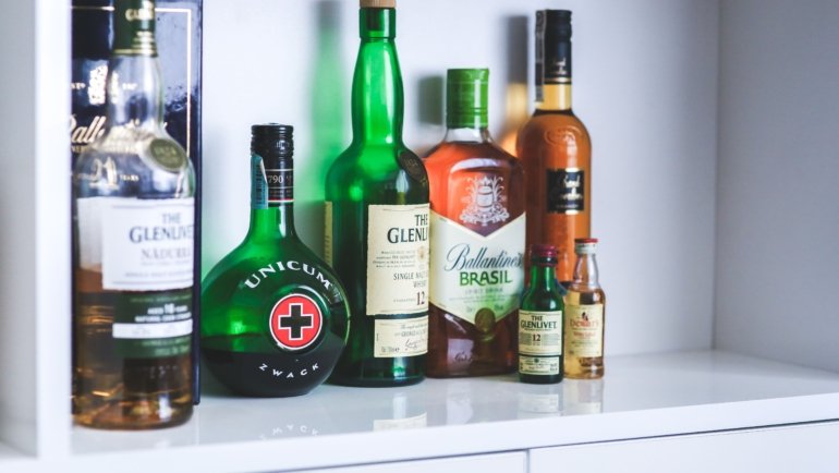 Traveler whiskey bottles displayed in an airport duty-free shop with exclusive packaging and travel retail pricing
