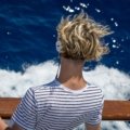 Person listening to music with headphones feeling inspired to travel and explore new destinations
