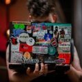 Colorful travel stickers decorating suitcase and laptop representing adventure and personalized travel gear