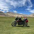 Motorcycle equipped with saddlebags, tank bag, and tail bag ready for long-distance travel