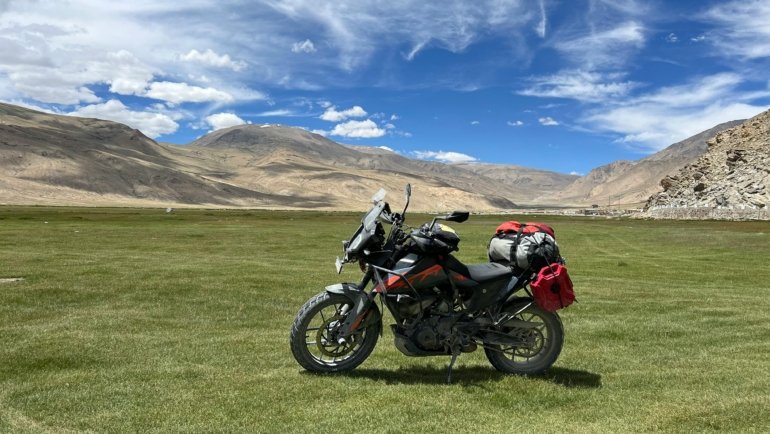 Motorcycle equipped with saddlebags, tank bag, and tail bag ready for long-distance travel