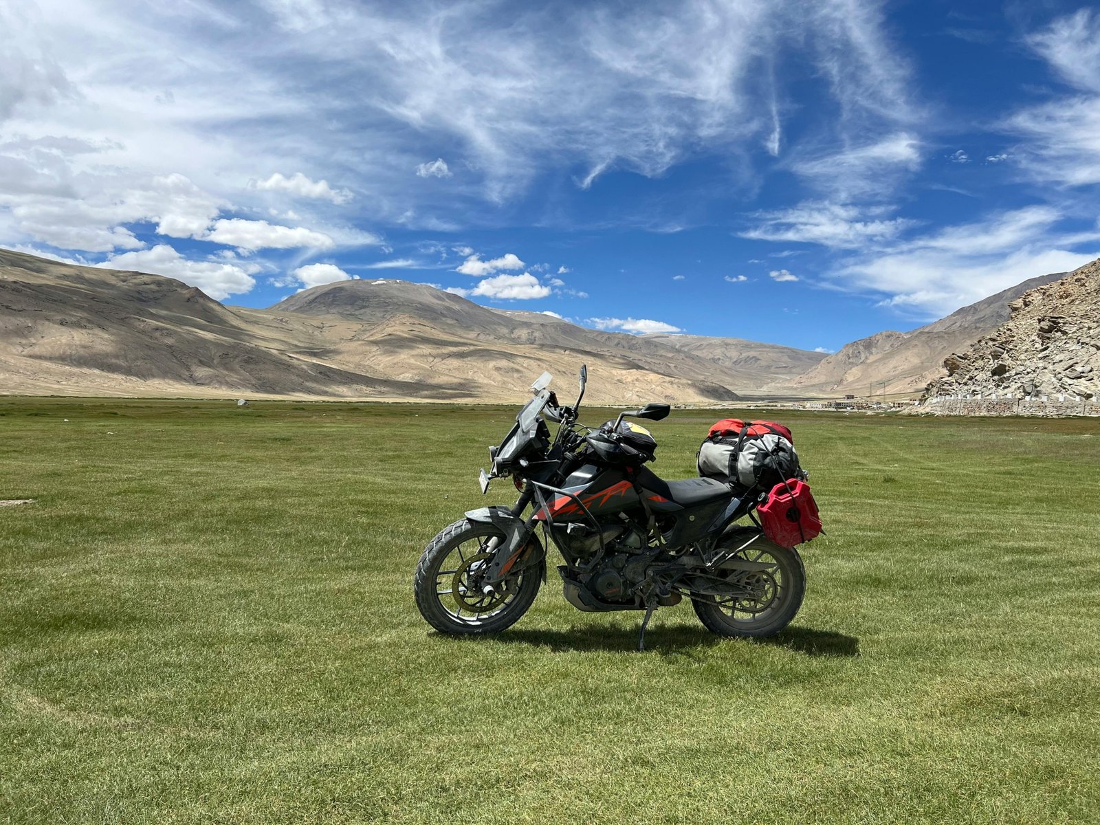 Motorcycle equipped with saddlebags, tank bag, and tail bag ready for long-distance travel