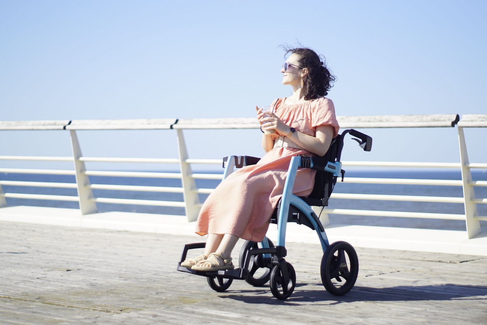 Lightweight foldable wheelchair for travel used by traveler in airport or outdoor setting, showcasing comfort and portability