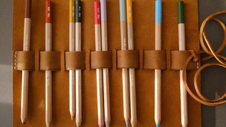 Compact and organized travel art kit being used outdoors for sketching and painting on the go