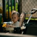 Safety 1st Smooth Ride Travel System moss green stroller with baby in outdoor environment showcasing safety and comfort