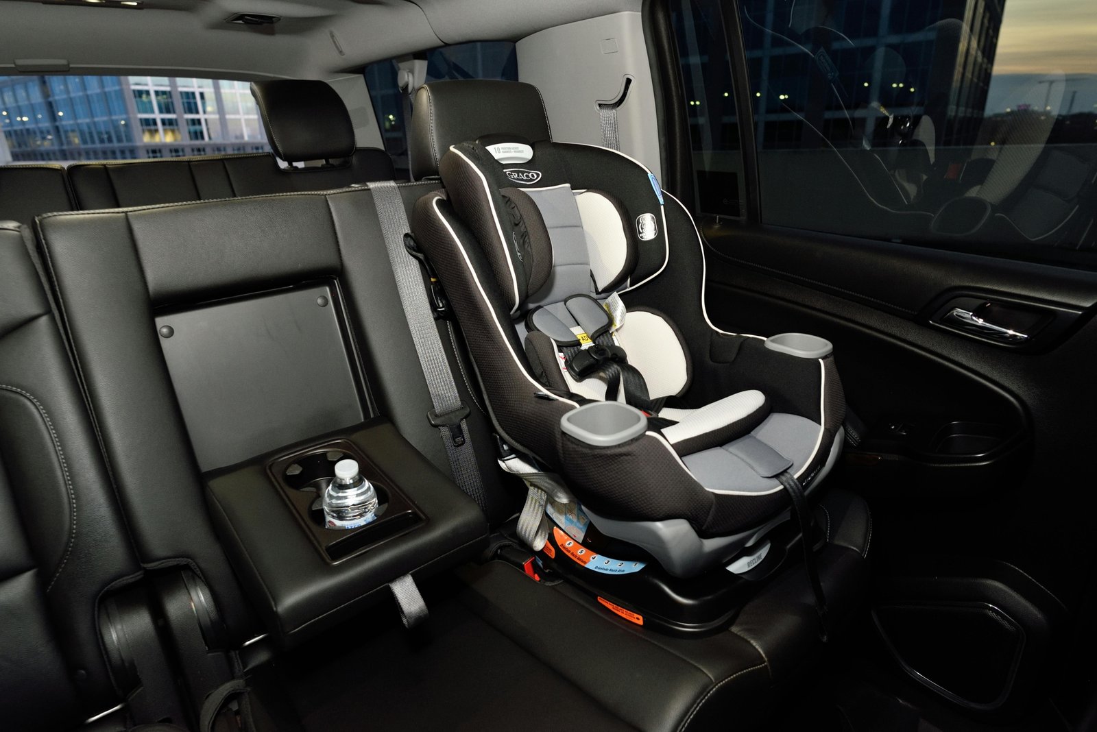 Infant safely secured in a travel car seat inside a car, demonstrating comfort and essential safety features for newborns