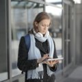 Traveler using portable power bank and smart luggage tracker during outdoor adventure in 2024