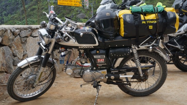 Motorcycle loaded with durable travel bags on an open road ready for a long-distance journey