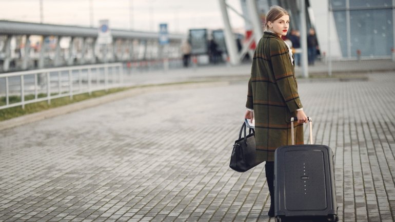 mz wallace stylish lightweight travel bag at airport with multiple compartments and durable design