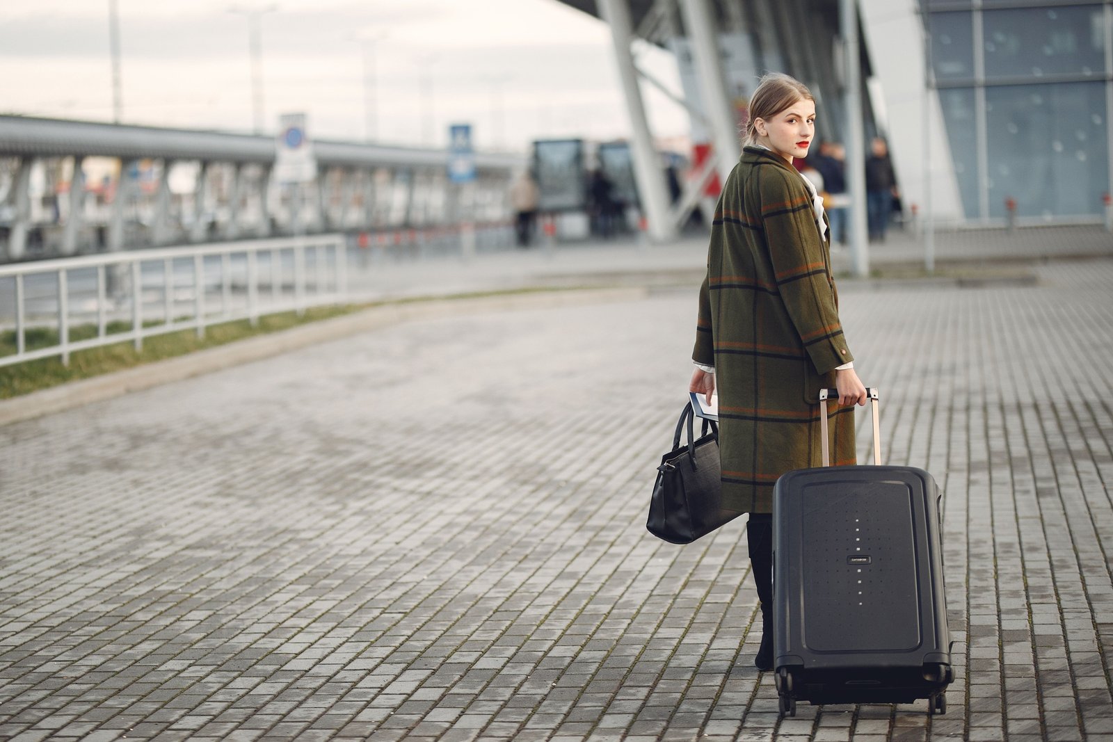 mz wallace stylish lightweight travel bag at airport with multiple compartments and durable design
