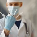 Travel nurse anesthetist preparing anesthesia in a hospital setting showcasing flexibility and diverse medical environments