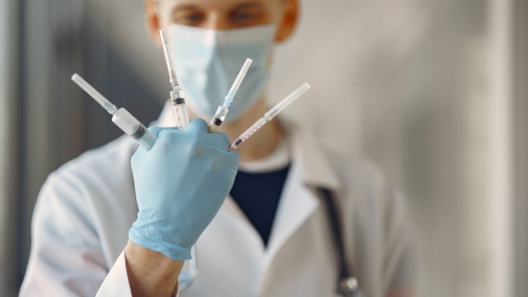 Travel nurse anesthetist preparing anesthesia in a hospital setting showcasing flexibility and diverse medical environments