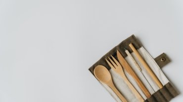 Eco-friendly travel cutlery set made of bamboo and stainless steel with carrying pouch outdoors