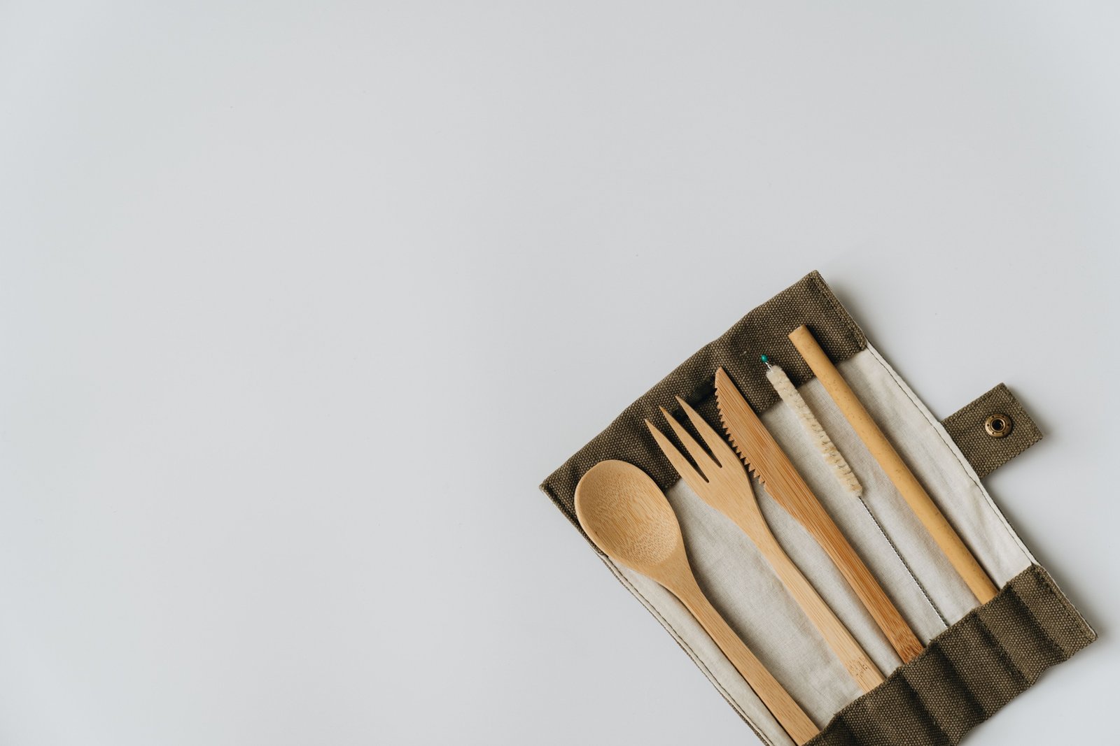 Eco-friendly travel cutlery set made of bamboo and stainless steel with carrying pouch outdoors