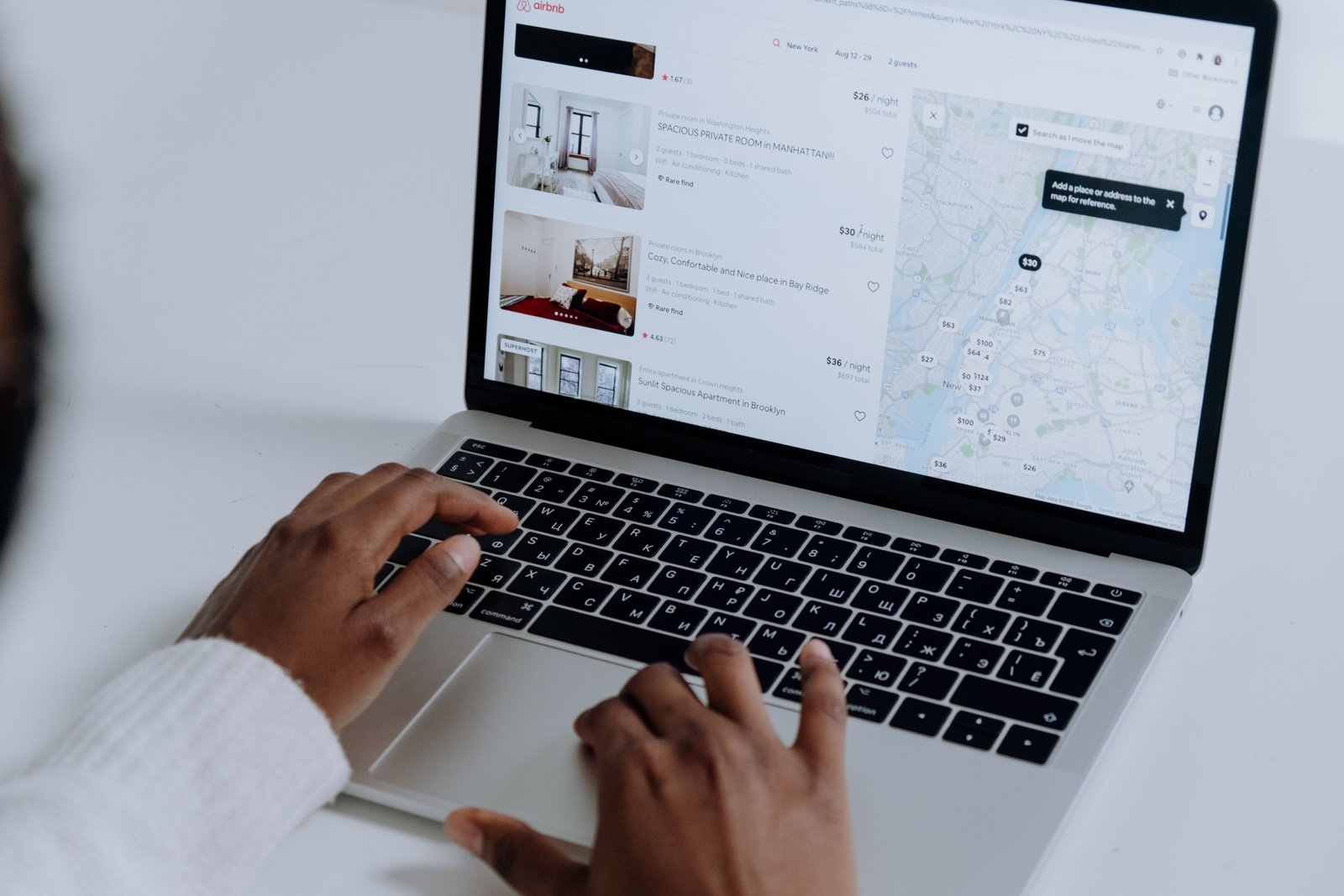 Person booking travel online using travel reservation booking technology for fast and efficient trip planning
