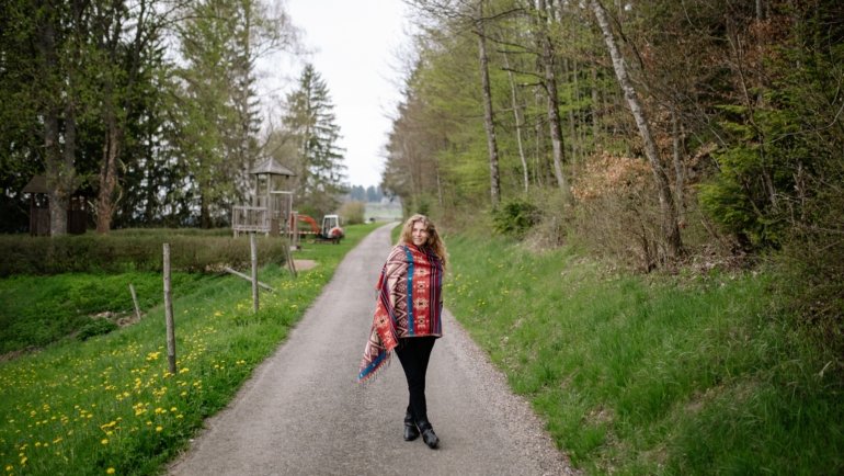 Traveler wearing a soft oversized travel shawl outdoors for warmth and style