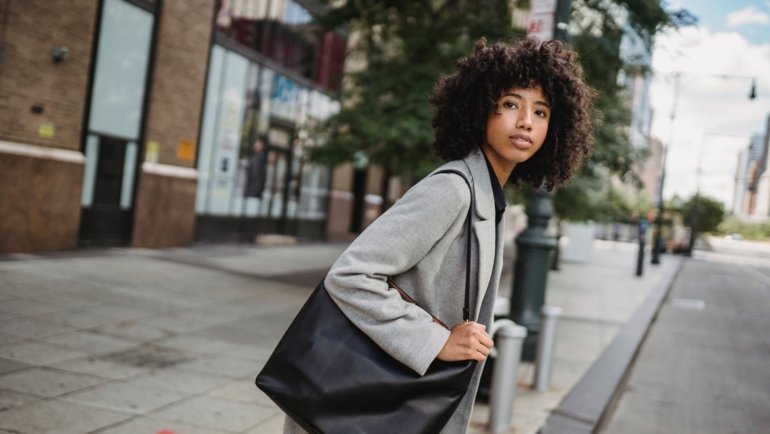Stylish woman carrying a secure and comfortable shoulder bag for travel in the city