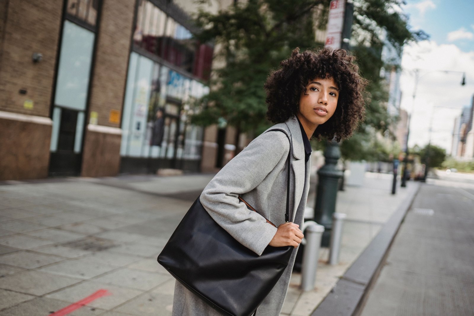 Stylish woman carrying a secure and comfortable shoulder bag for travel in the city