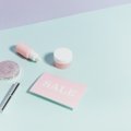 Travel-sized moisturizer with travel essentials showcasing skincare routine on the go