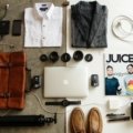 Men's leather travel toiletry bag organized for grooming essentials on a travel surface