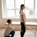 Travel physical therapist providing treatment to a patient in a modern clinic, representing flexibility and career growth in travel therapy jobs