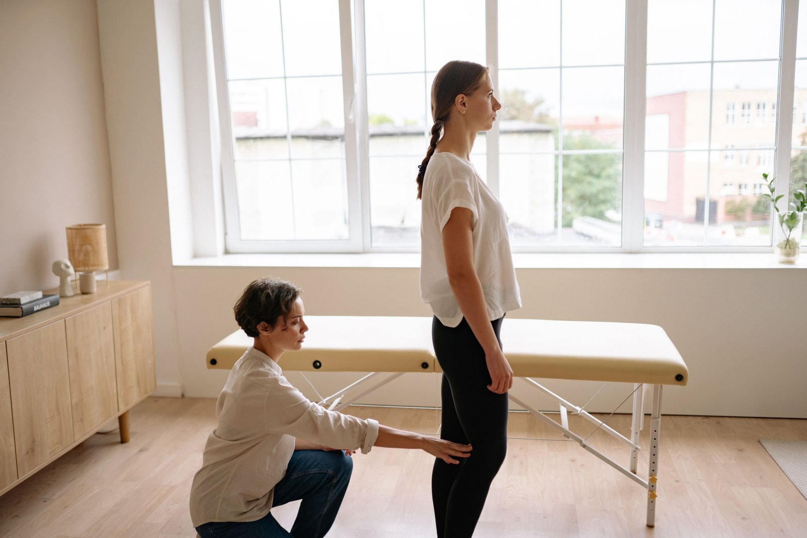 Travel physical therapist providing treatment to a patient in a modern clinic, representing flexibility and career growth in travel therapy jobs