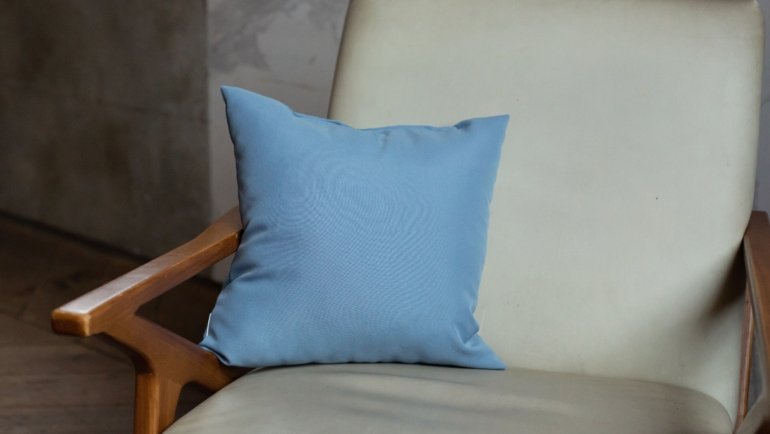Traveler using an ergonomic travel lumbar pillow for back support and comfort during long trips