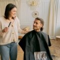 Traveling hairdresser giving a salon-quality haircut to a client at home, showcasing personalized mobile hairstyling service
