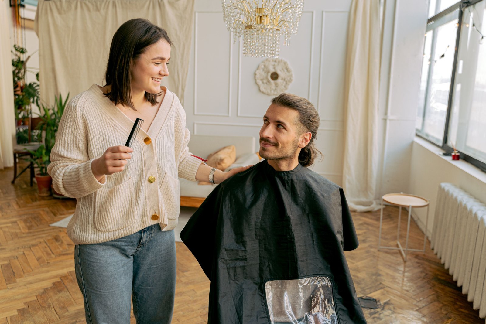 Traveling hairdresser giving a salon-quality haircut to a client at home, showcasing personalized mobile hairstyling service