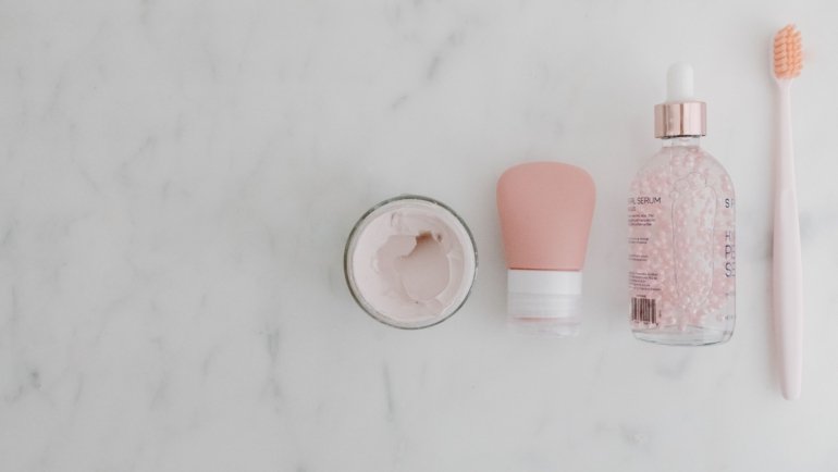 Rodan and Fields travel size skincare products arranged with travel accessories for convenient skincare routine on the go