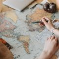 Traveler using a San Diego travel guide book and map to plan a trip to California