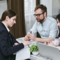 Travel agent helping client plan a vacation in Pittsburgh travel agency office