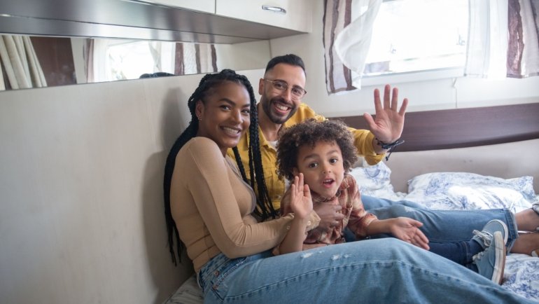 Family enjoying spacious travel trailer that sleeps six with comfortable interiors and travel adventure