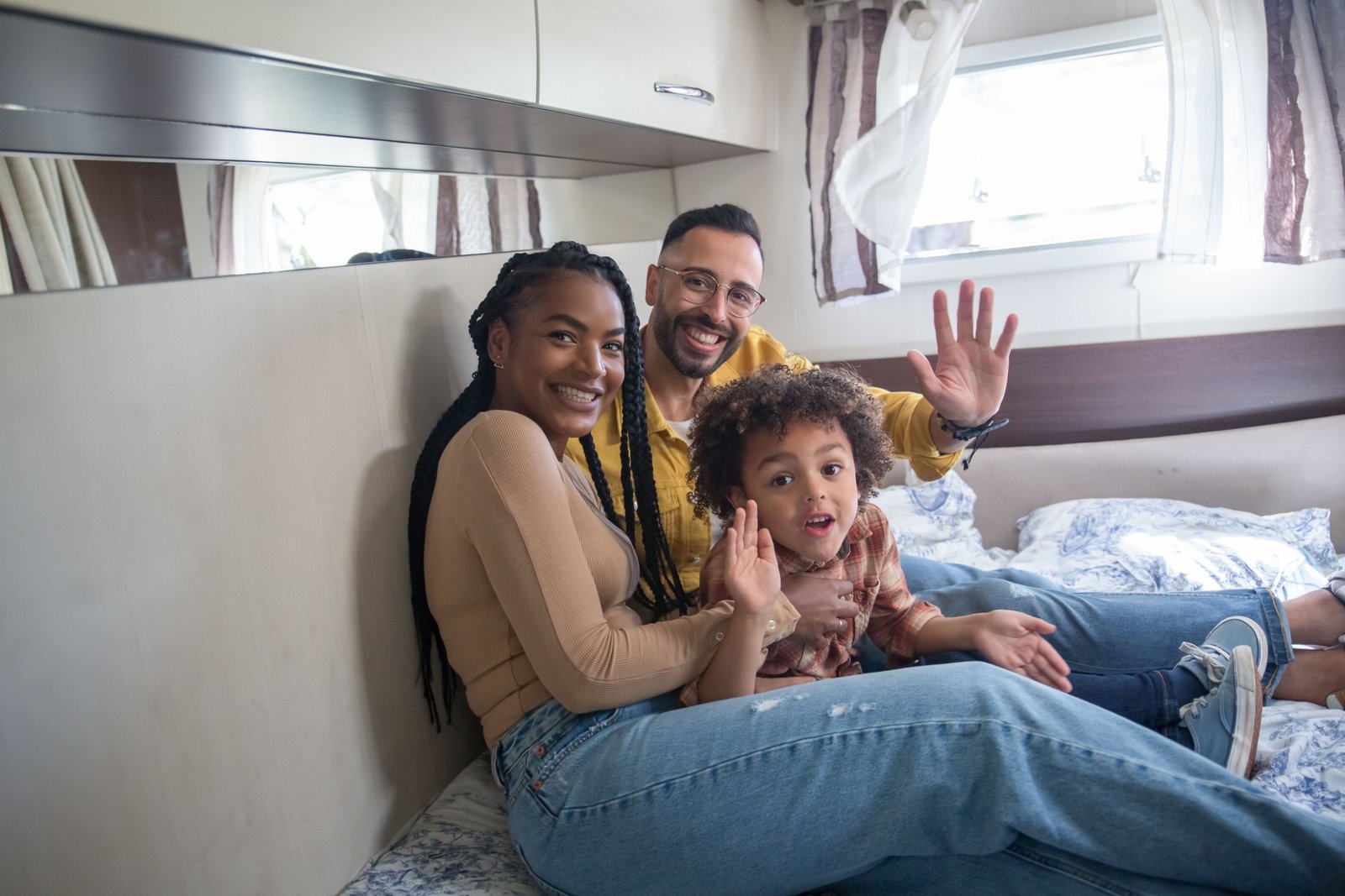 Family enjoying spacious travel trailer that sleeps six with comfortable interiors and travel adventure