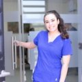 Happy female travel nurse working in a modern hospital, representing flexible nursing career and travel opportunities