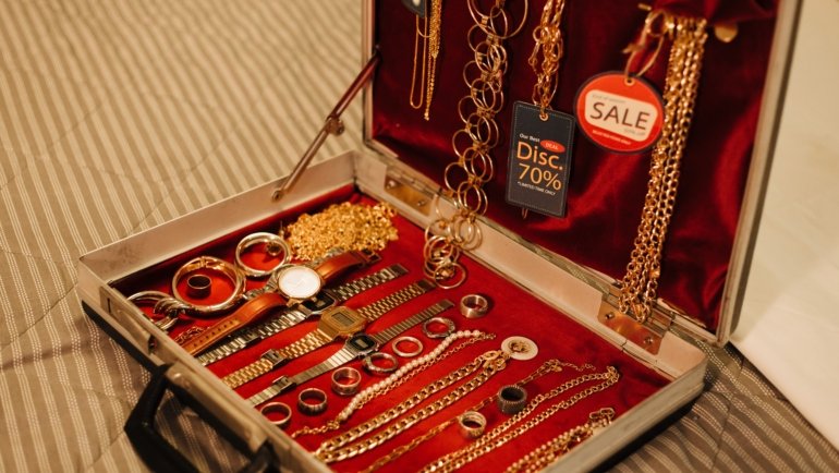 Large jewelry travel case open with organized compartments containing necklaces, rings, and bracelets for secure and convenient travel