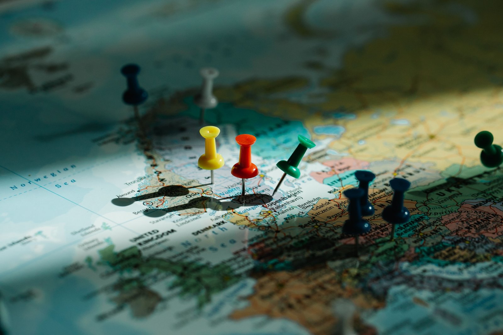 Colorful push pin travel map on wall with pins marking visited travel destinations