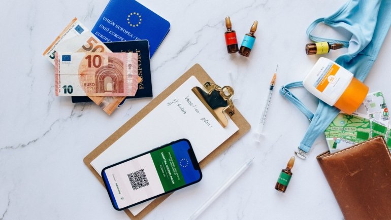 Traveler preparing important documents, health kit, and essentials for safe and well-organized international travel