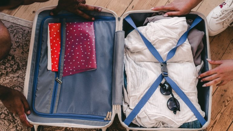Travel laundry bag inside an organized suitcase for clean and dirty clothes separation during travel
