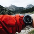 Close-up of a durable travel watch on a traveler's wrist in an outdoor setting showcasing style and functionality