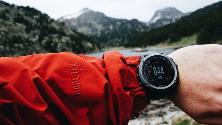 Close-up of a durable travel watch on a traveler's wrist in an outdoor setting showcasing style and functionality
