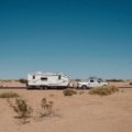 Pickup truck towing a travel trailer on a highway for safe and efficient travel