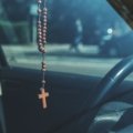 Catholic traveler praying for safety and protection before a journey
